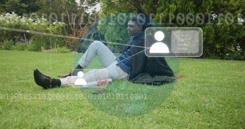 Young man sitting and leaning on grass using jacket as pillow with ar overlay and binary code