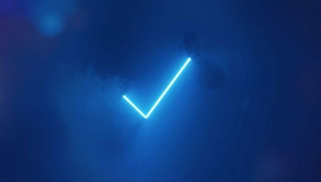 Glowing neon check mark against hypnotic blue smoke