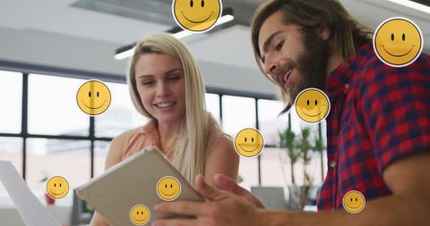 Business Colleagues Using Tablet with Media Icons