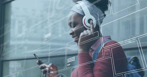 Young Adult Enjoying Music with Headphones and Smartphone