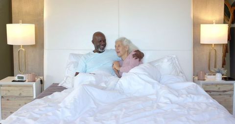 Happy Senior Couple Relaxing in Bed Showing Intimate Bond