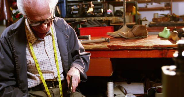 Shoemaker hammering on a shoe in workshop 4k