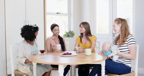 Diverse Group of Smiling Women Celebrating Engagement at Home