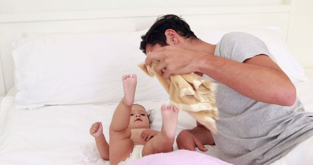 Father Changing Diaper of Baby on Bed in Bright Bedroom - Download Free Stock Images Pikwizard.com