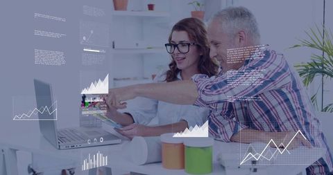 Colleagues Collaborating on Data with Graphs and Laptop in Office