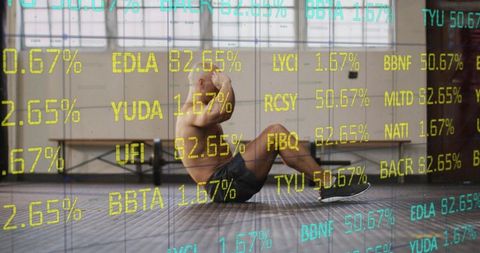Shirtless athlete performing situps in industrial gym with financial ticker overlay