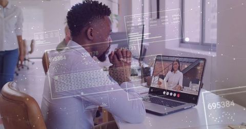 Professional Man in Tech Office Engaged in Virtual Meeting with Digital Overlays