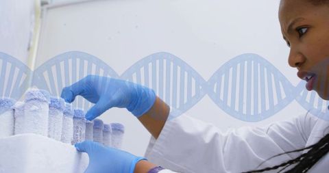 Female scientist handling frozen cryogenic vials for dna testing in clinical laboratory