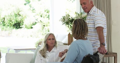 Elderly friends enjoying conversation at home