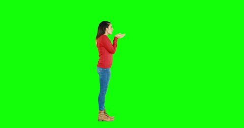 Brunette Woman Blowing Whisper Toward Camera on Green Screen - Download Free Stock Images Pikwizard.com