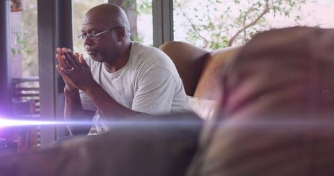 Senior Man Contemplating Serenity in Cozy Home