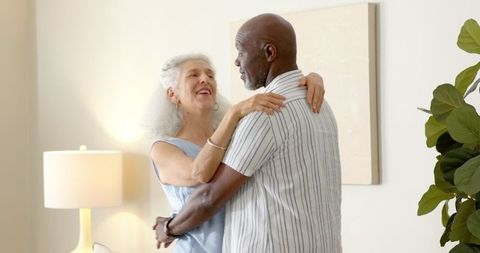 Senior Couple Embracing Bliss While Dancing at Home
