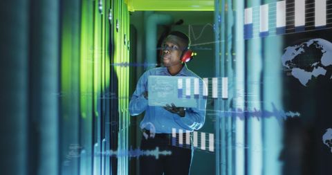 IT Engineer Managing Server Room with Futuristic Data Visuals - Download Free Stock Images Pikwizard.com
