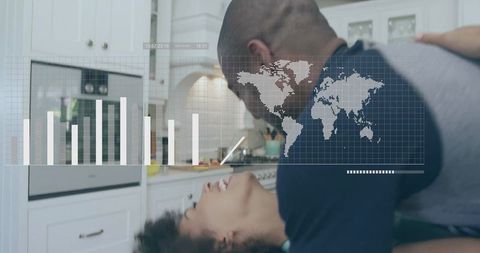 Couple embracing on kitchen countertop with digital data overlay and world map analytics