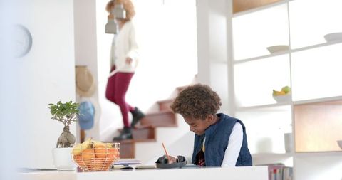 Energetic Boy Focused on Homework at Home