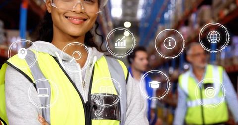 Smiling warehouse team leader wearing safety vest and goggles with digital hud icons