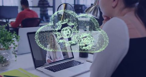 Businesswoman collaborating via cloud hologram on laptop in open office workspace