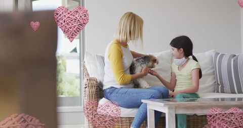 Mother and Daughter with Masks Enjoying Dog Inside Cozy Home