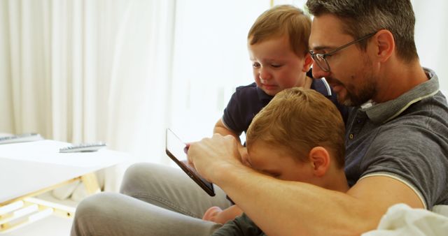 Father Bonding with Children on Couch Holding Tablet - Download Free Stock Images Pikwizard.com