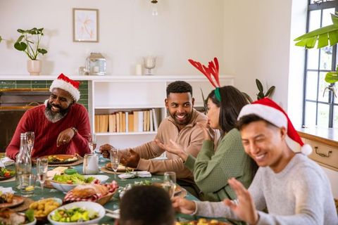Diverse Family Enjoying Festive Meal Together During Holidays