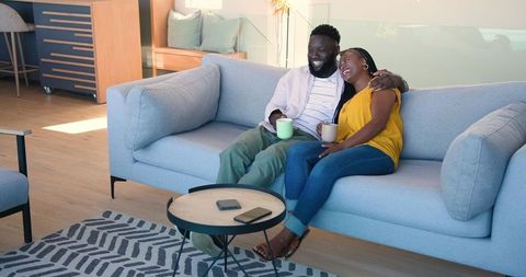 Couple Relaxing with Coffee in Modern Living Room