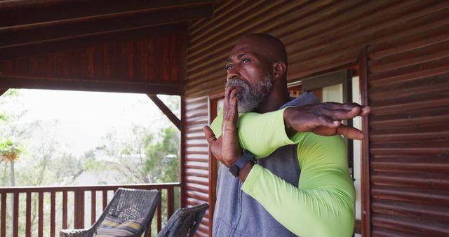 Mature African American Man Stretching on Wooden Porch - Download Free Stock Images Pikwizard.com