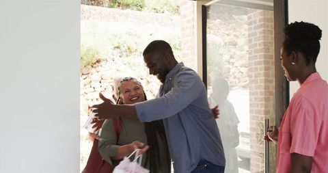Happy Family Greeting Visitors with Warm Embrace