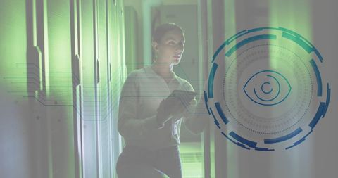 Engineer using tablet in secure data server room with digital eye interface