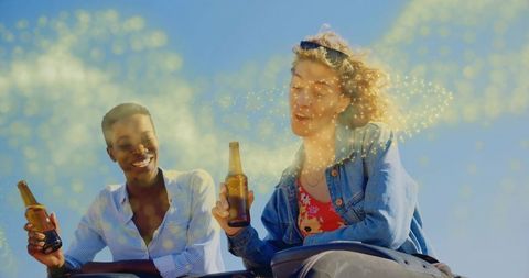 Friends Relaxing Outside with Drinks under Scenic Sky