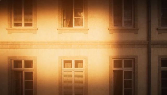Sunlight bathing classic stucco facade with shuttered windows and soft shadows
