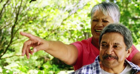 Happy senior latino couple enjoying outdoors together