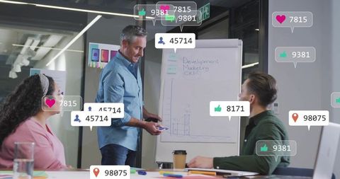 Executive presenting on flip chart with social media overlays during team workshop in office
