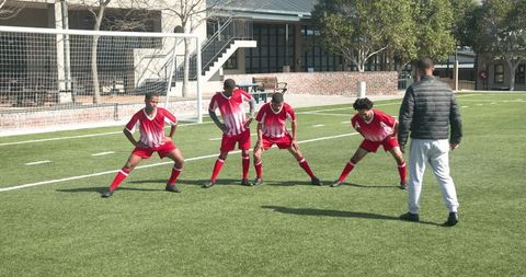 Soccer teammates practicing sportsmanship on field