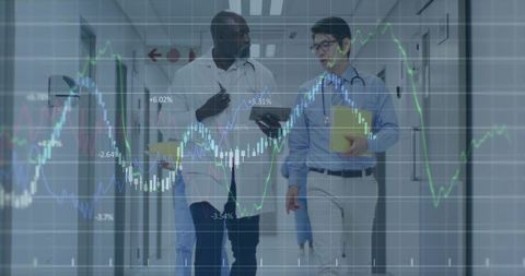 Doctors consulting while walking hospital corridor with medical data analytics overlay