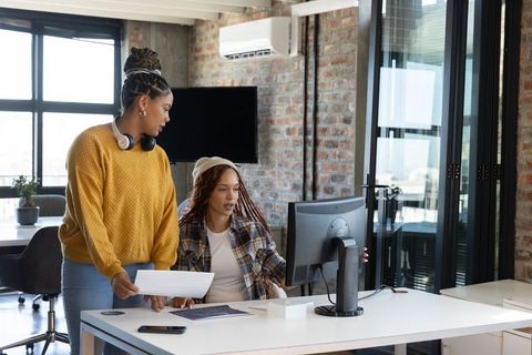 Professional African American Women Collaborating in Modern Office