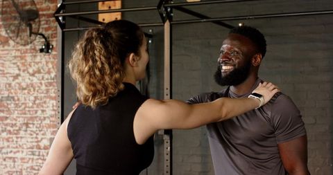 Trainer encouraging client with strength training routine
