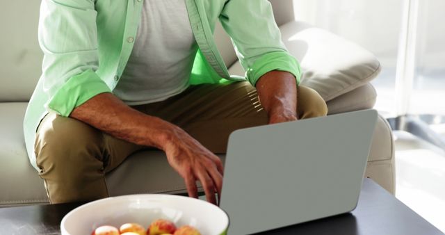 Man in Green Shirt Working on Laptop at Home - Download Free Stock Images Pikwizard.com