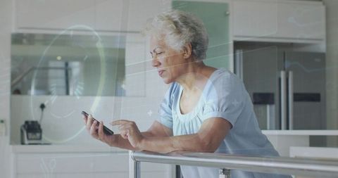Mature woman leaning on railing tapping smartphone for remote health monitoring