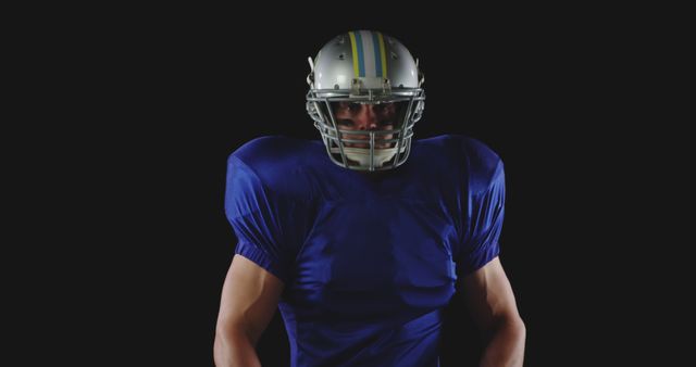 Confident American Football Player Posed in Uniform against Black Background - Download Free Stock Images Pikwizard.com