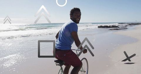 Man Cycling on Sandy Beach Enjoying Outdoor Adventure