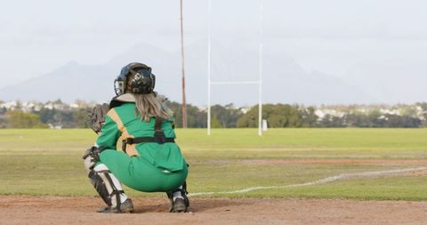 Female baseball catcher in action at outdoor sports field