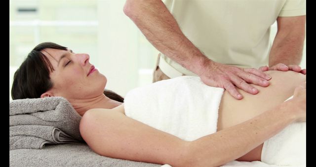 Pregnant Woman Receiving Prenatal Massage at Wellness Center - Download Free Stock Images Pikwizard.com