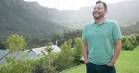 Man enjoying scenic mountain view with smiling expression