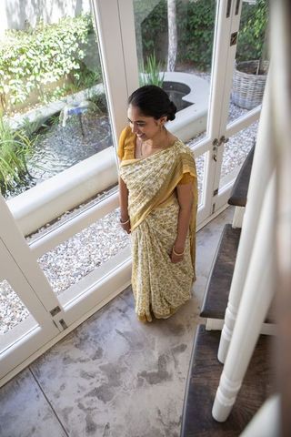 Elegant woman in saree enjoying sunroom ambiance