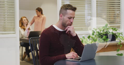 Focused Businessman with Digital World Map in Office