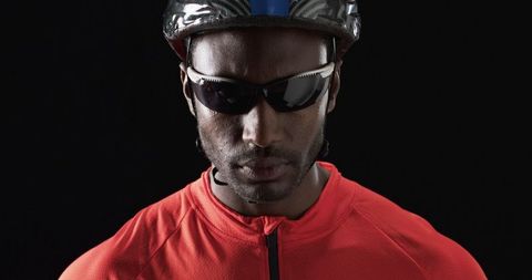 Confident Cyclist in Sporty Red Attire against Black Background