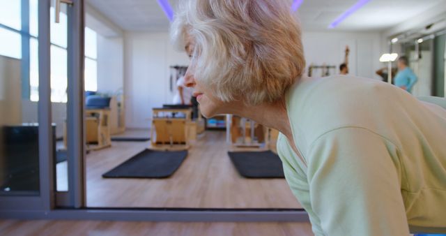 Senior Woman Practicing Yoga in Modern Studio - Download Free Stock Images Pikwizard.com