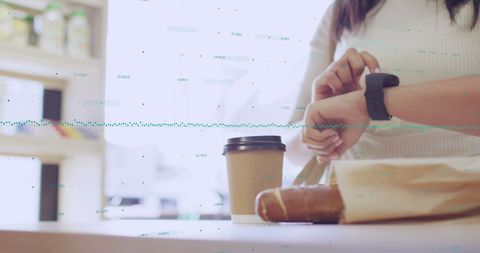 Woman Using Smartphone in Smart Coffee Shop Displaying Data