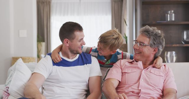 Three Generations of Men Bonding, Laughing and Smiling on Cozy Living Room Sofa - Download Free Stock Images Pikwizard.com