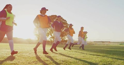 Softball Players Warming up at Sunrise on Field